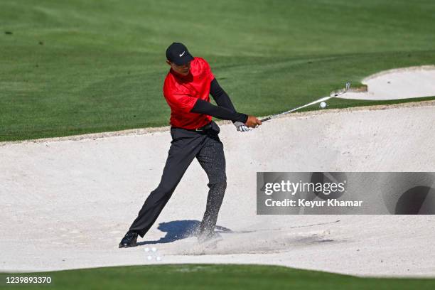 Tiger Woods hits a bunker shot in the tournament practice area during the final round of the Masters at Augusta National Golf Club on April 10 in...