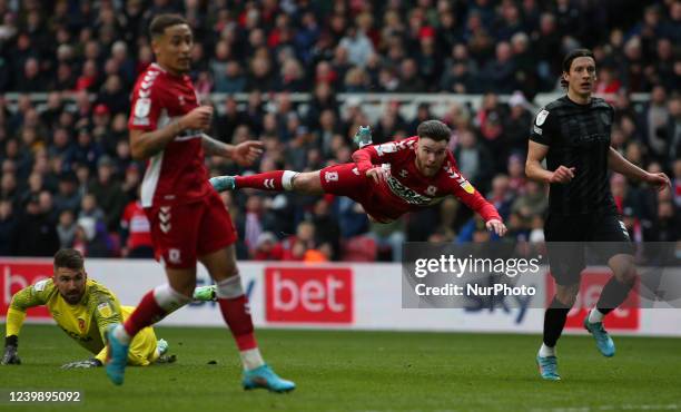 Middlesbrough's Aaron Connolly flys through the air after beating Hull City Goalkeeper Matt Ingram during the Sky Bet Championship match between...