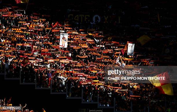 Roma's supporters wave scarves during the Serie A football match between AS Roma and Salernitana at The Olympic Stadium in Rome on April 10, 2022.