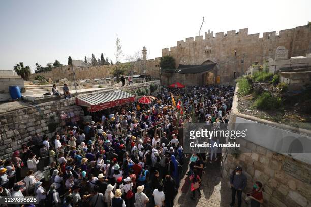 People take part in the Palm Sunday procession in Jerusalem on April 10, 2022. Palm Sunday is celebrated on last Sunday before the 'Easter' for...