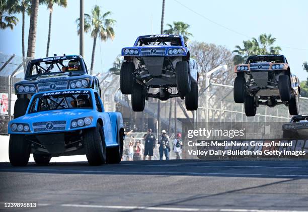 Long Beach, CA Stadium Super Truck drivers Max Gordon, Davey Hamilton Jr., Robert Stout and Jerett Brooks all go airborne off a jump on Pine Avenue...