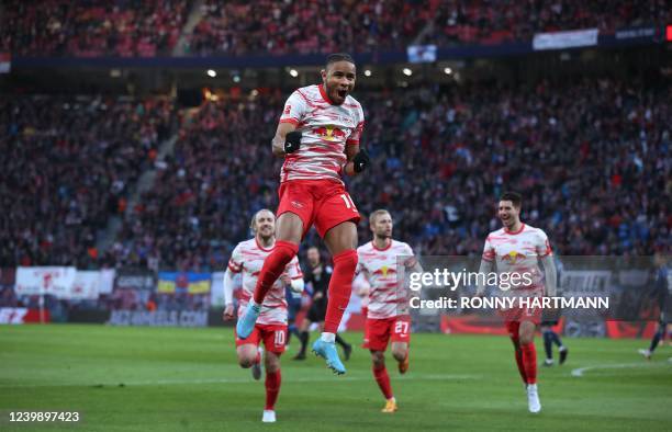 Leipzig's French midfielder Christopher Nkunku celebrates scoring the opening goal with his teammates during the German first division Bundesliga...