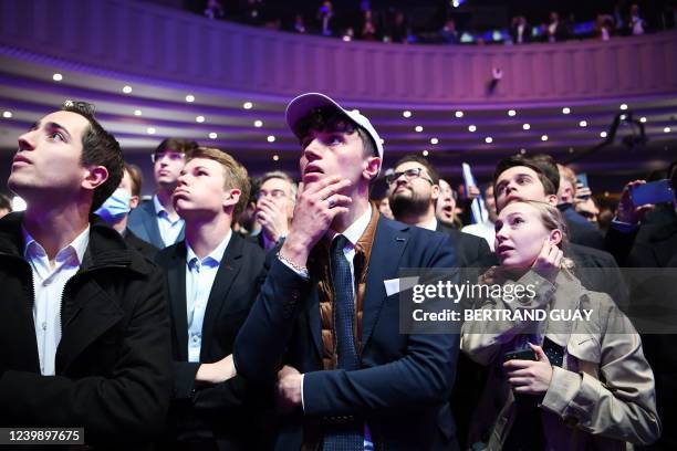 Supporters of French far-right party Reconquete! presidential candidate Eric Zemmour react in Paris on April 10, 2022 after projected results are...