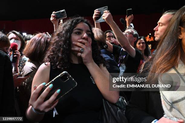 French leftist party La France Insoumise presidential candidate Jean-Luc Melenchon's supporter reacts at Cirque D'Hiver in Paris on April 10 after...