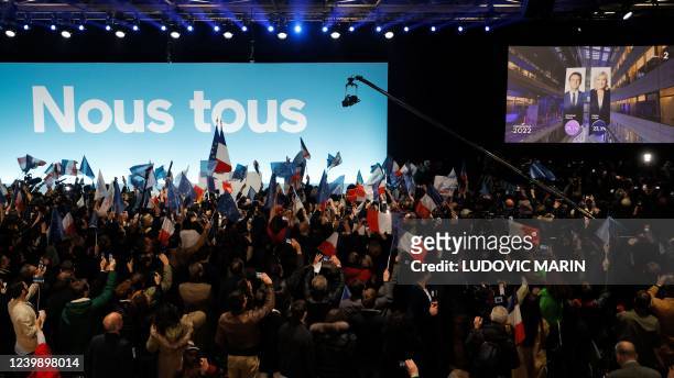 La Republique en Marche party's supporters react as results of the first round of France's presidential election appears on a giant screen at the...