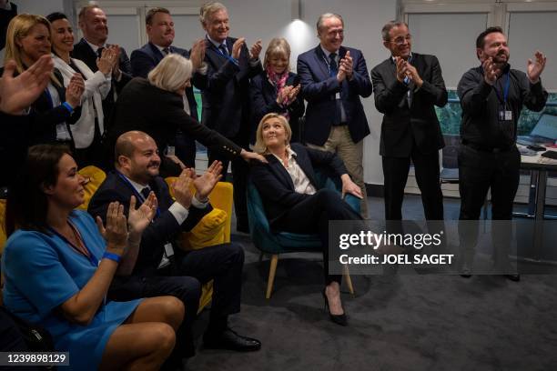 French far-right party Rassemblement National's presidential candidate Marine Le Pen reacts after the first results of the first round of the...