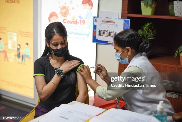 Beneficiary receives a Booster dose of Covid-19 vaccine at Star Imaging Labs, Tilak Nagar, on April 10, 2022 in New Delhi, India. All adults can get...