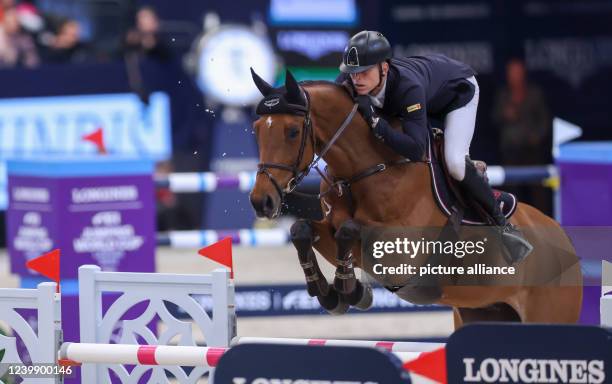 April 2022, Saxony, Leipzig: Max Kühner from Austria rides Elektric Blue P in the final of the Longines Fei Jumping World Cup at the Leipzig Fair....