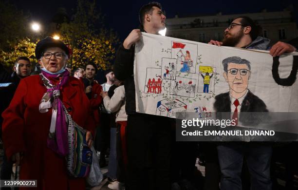 French leftist party La France Insoumise presidential candidate Jean-Luc Melenchon supporters hold a banner outside Cirque D'Hiver in Paris on April...