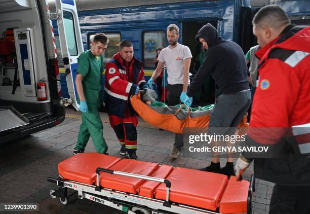 Ambulance team and MSF medics transfer a patient to an ambulance in Kyiv on April 10, 2022. - Doctors Without Borders , in cooperation with the...