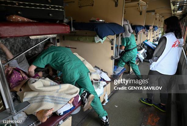 An MSF team care for patients on a medical evacuation train on its way to the western Ukrainian city of Lviv on April 10, 2022. - Doctors Without...