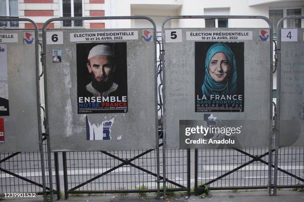 Posters depicting candidates competing in presidential election, in their most opposing states, made by French street artist Jaeraymie are seen on...