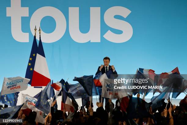 French President and La Republique en Marche party candidate for re-election Emmanuel Macron gestures as he addresses sympathizers after the first...