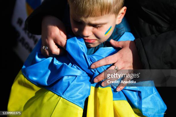 Young boy attends 'Mothers' March' as part of Stand with Ukraine international protest, in Krakow, Poland on April 10, 2022. Ukrainian mothers and...