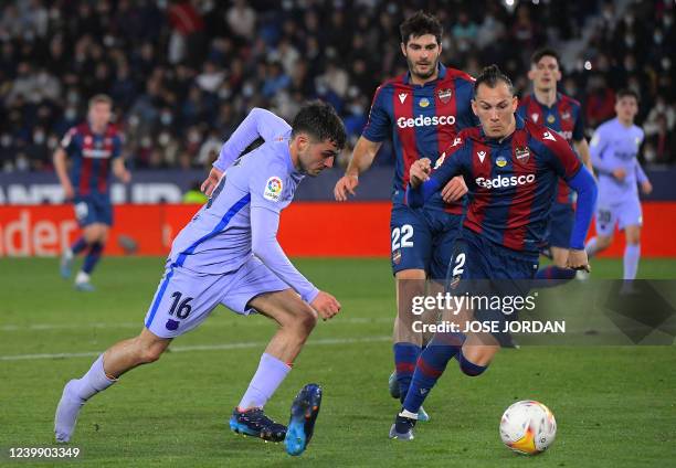 Barcelona's Spanish midfielder Pedri loses his shoe as he vies with Levante's Spanish defender Son during the Spanish league football match between...