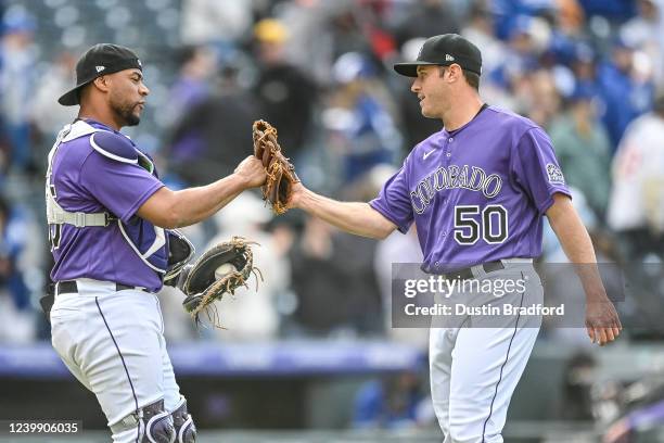 Elias Diaz of the Colorado Rockies celebrates with Ty Blach after Blach picked up a four inning save against the Los Angeles Dodgers at Coors Field...