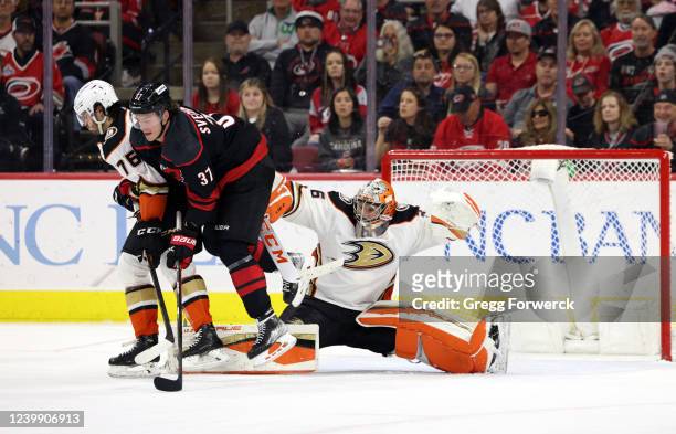 Andrei Svechnikov of the Carolina Hurricanes creates traffic in front of the net as goaltender John Gibson of the Anaheim Ducks goes down in the...