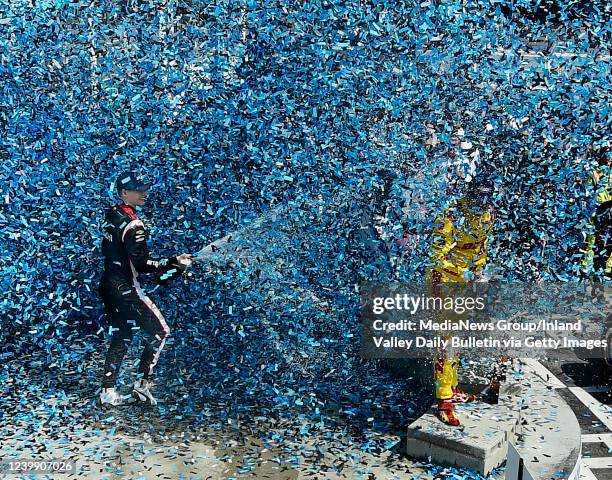 Long Beach, CA Race winner Josef Newgarden sprays second place finisher Romain Grosjean with champagne as they celebrate in victory lane following...