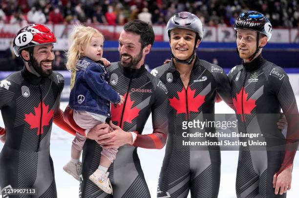 Charles Hamelin of Canada looks at his daughter after the 5000m relay at the World Short Track Speed Skating Championships at Maurice Richard Arena...