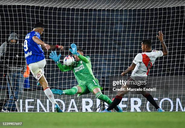Franco Armani of River Plate makes a save against Gabriel Avalos of Argentinos Juniors during a match between River Plate and Argentinos Juniors as...
