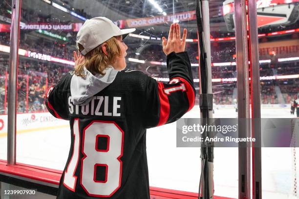 Young fan cheers on a first period goal by the Ottawa Senators against the Winnipeg Jets at Canadian Tire Centre on April 10, 2022 in Ottawa,...