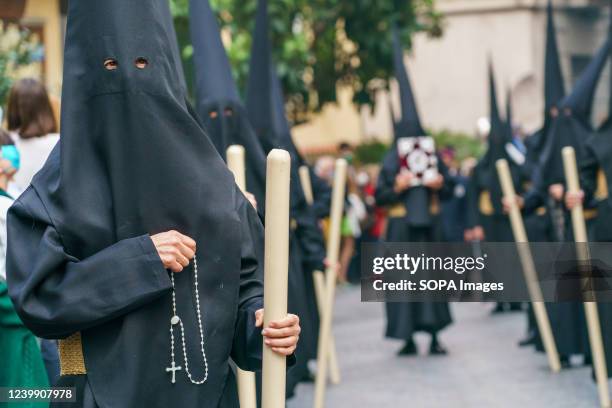 Nazarenes seen holding a rosary during the procession of the students through the streets of the center of Madrid. After two years interrupted by the...