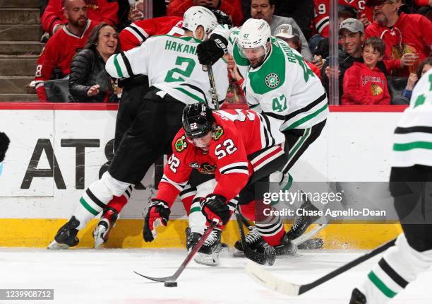 Reese Johnson of the Chicago Blackhawks gets to the puck ahead of Alexander Radulov of the Dallas Stars during the second period at United Center on...