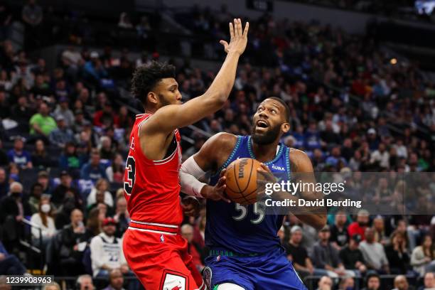 Greg Monroe of the Minnesota Timberwolves drives against Tony Bradley of the Chicago Bulls in the first quarter at Target Center on April 10, 2022 in...