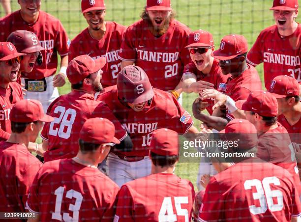 Stanford designated hitter Vincent Martinez gets mobbed by teammates after slamming a 3-run home run in the bottom of the 4th inning in the game...