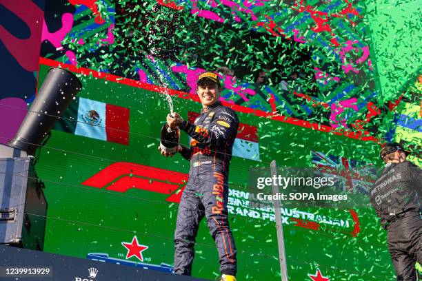 Sergio Perez of Mexico and Red Bull Racing celebrates on the podium after placing second in the 2022 Australian Grand Prix at the Albert Park Grand...