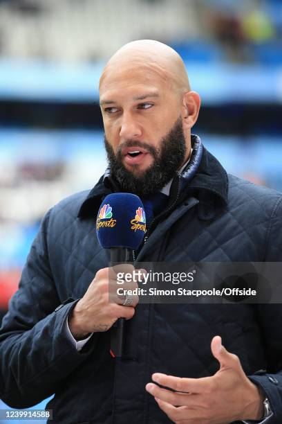 Goalkeeper Tim Howard works as a pitchside pundit for NBC Sports television during the Premier League match between Manchester City and Liverpool at...