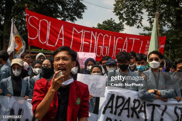 Students hold placards and a banner during the protest on April 11 in Gedung Sate, Bandung City, West Java. They protested against high supply...