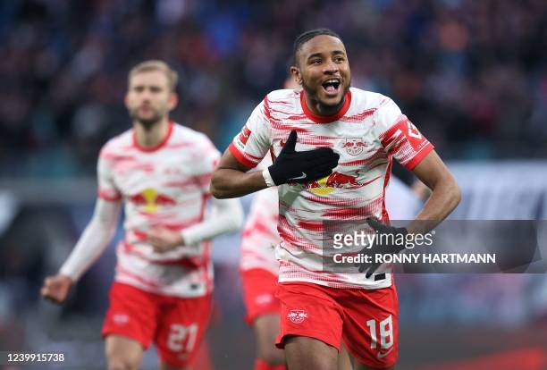 Leipzig's French midfielder Christopher Nkunku celebrates scoring the opening goal during the German first division Bundesliga football match RB...