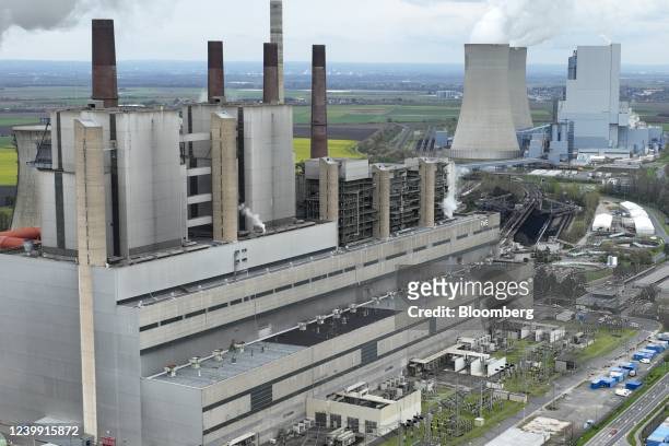 Cooling towers emit vapor at the Neurath lignite fueled power station, operated by RWE AG, in Grevenbroich, Germany, on Friday, April 8, 2022....