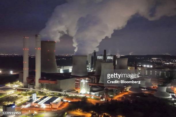 Cooling towers emit vapor at the Niederaussem lignite fueled power station, operated by RWE AG, in Bergheim Niederaussem, Germany, on Friday, April...