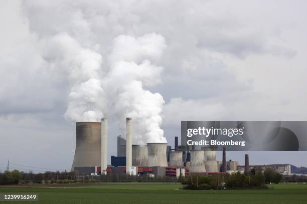 Cooling towers emit vapor at the Niederaussem lignite fueled power station, operated by RWE AG, in Bergheim Niederaussem, Germany, on Friday, April...