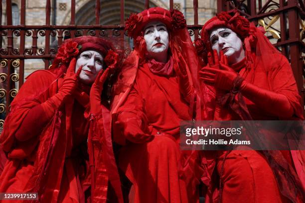 Member of the Red Rebel Brigade perform outside the Natural History Museum during an Extinction Rebellion protest on April 11, 2022 in London,...