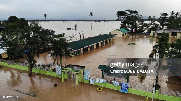 An aerial photo shows a school building submerged by flood waters in Abuyog town, Leyte province, southern Philippines, on April 11 following heavy...