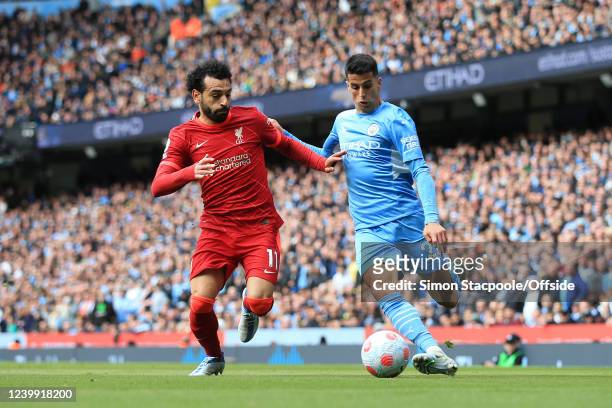 Mohamed Salah of Liverpool battles with Joao Cancelo of Manchester City during the Premier League match between Manchester City and Liverpool at...