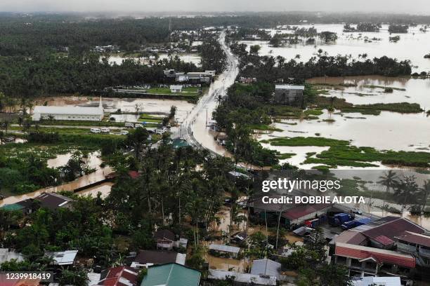 An aerial photo shows highway and houses submerged by flood waters in Abuyog town, Leyte province, southern Philippines, on April 11 following heavy...