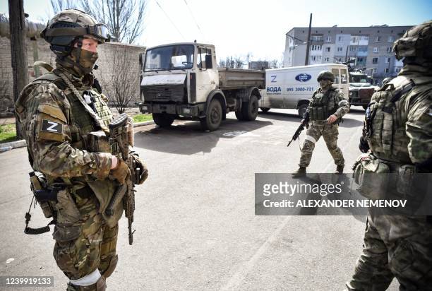 Russian soldiers patrol a street on April 11 in Volnovakha in the Donetsk region. The picture was taken during a trip organized by the Russian...
