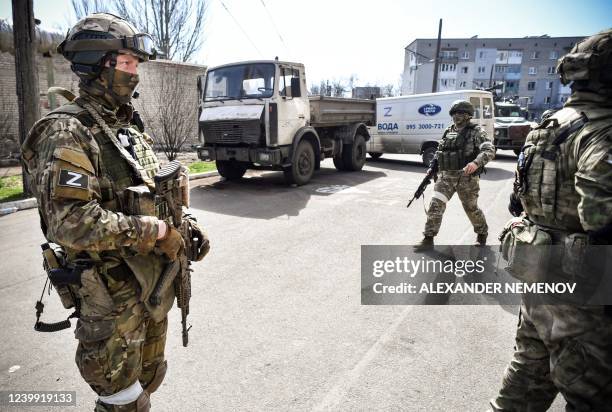 Russian soldiers patrol a street on April 11 in Volnovakha in the Donetsk region. The picture was taken during a trip organized by the Russian...