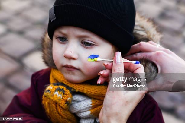 Child attends 'Mothers' March' as part of Stand with Ukraine international protest, in Krakow, Poland on April 10, 2022. Ukrainian mothers and...