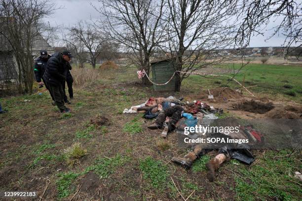 Police officers are investigating near the bodies of people killed by the Russian military in the village of Havronshchyna, Kyiv region. On March 14...