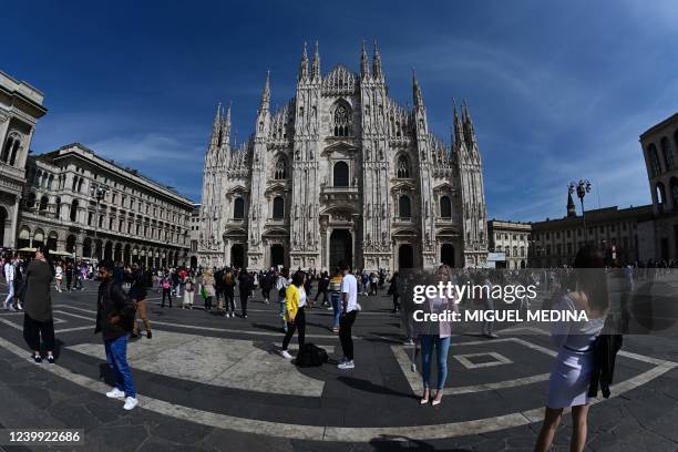 Fisheye lens taken on April 11, 2022 shows tourists posing in front of the Duomo di Milano on Duomo square, in central Milan.