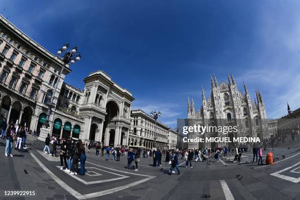 Photograph taken with a fishey lens on April 11, 2022 shows people strolling in front of the entrance of the Galleria Vittorio Emanuele II and the...