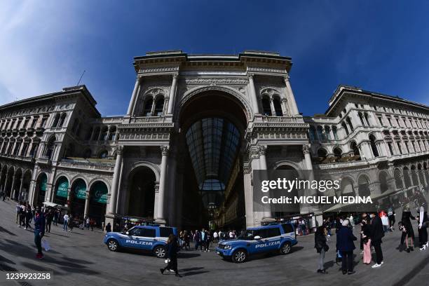 Photograph taken with a fishey lens on April 11, 2022 shows police cars patrolling in front of the Galleria Vittorio Emanuele II on Duomo square, in...