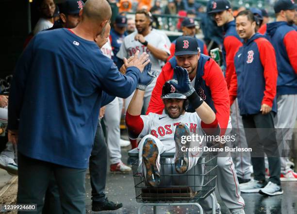 April 11: J.D. Martinez of the Boston Red Sox is pushed through the dugout in a laundry cart by Kevin Plawecki after hitting a solo home run against...