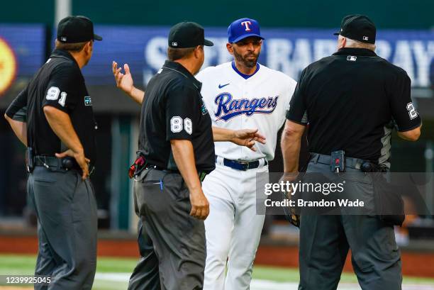 Manager Chris Woodward of the Texas Rangers argues a slide interference call that ended the game in the 10th inning against the Colorado Rockies in...