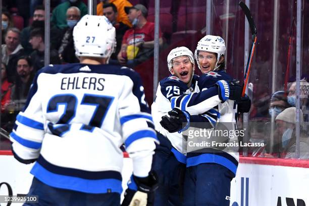 Morgan Barron of the Winnipeg Jets celebrates with teammate Paul Stastny after scoring a goal against the Montreal Canadiens in the NHL game at the...